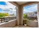 Relaxing balcony view with decorative railing overlooking mature trees and clear blue skies at 15221 N Clubgate Dr # 2132, Scottsdale, AZ 85254