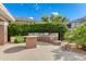 Outdoor barbecue area with built-in grills, counter space, and a dining table for residents to enjoy outdoor cooking at 15221 N Clubgate Dr # 2132, Scottsdale, AZ 85254