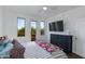 Bright bedroom with access to a balcony, featuring dark wood floors and ample natural light at 15221 N Clubgate Dr # 2132, Scottsdale, AZ 85254