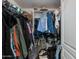 Walk-in closet with metal shelving and hanging rods for storage at 15221 N Clubgate Dr # 2132, Scottsdale, AZ 85254