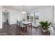 Bright dining area with hardwood floors, a modern chandelier, and a glimpse into the living area at 15221 N Clubgate Dr # 2132, Scottsdale, AZ 85254