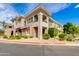 Charming two-story townhome with manicured landscaping, stucco, and a glimpse of private balconies in a well-maintained neighborhood at 15221 N Clubgate Dr # 2132, Scottsdale, AZ 85254