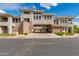 Inviting exterior of a multi-story townhome featuring stucco and a covered car port against a backdrop of blue sky and clouds at 15221 N Clubgate Dr # 2132, Scottsdale, AZ 85254