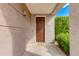 Inviting front entry with a rich wood door, showcasing the address, and a welcoming green landscape at 15221 N Clubgate Dr # 2132, Scottsdale, AZ 85254
