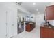 Kitchen featuring granite countertops, white tile flooring, and wood cabinets, providing functionality and style at 15221 N Clubgate Dr # 2132, Scottsdale, AZ 85254