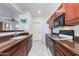 Efficient kitchen layout with brown cabinets and sleek appliances, perfect for cooking and meal preparation at 15221 N Clubgate Dr # 2132, Scottsdale, AZ 85254