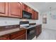 Well-lit kitchen with dark wood cabinets, offering ample counter space and a view into adjacent living areas at 15221 N Clubgate Dr # 2132, Scottsdale, AZ 85254