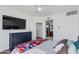 Bright main bedroom with a large TV and a view to the ensuite bathroom at 15221 N Clubgate Dr # 2132, Scottsdale, AZ 85254