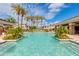 Community pool with lounge chairs and covered ramadas and tropical landscaping at 15221 N Clubgate Dr # 2132, Scottsdale, AZ 85254