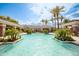 Community pool with tropical landscaping including mature palm trees and flowering plants at 15221 N Clubgate Dr # 2132, Scottsdale, AZ 85254