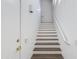 Bright staircase featuring modern white walls, brown wood steps and white risers leading to upper level at 15221 N Clubgate Dr # 2132, Scottsdale, AZ 85254