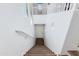 Bright staircase featuring modern white walls, brown wood steps and white risers leading to lower level at 15221 N Clubgate Dr # 2132, Scottsdale, AZ 85254