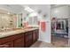 Spacious bathroom with double sinks, granite countertops, and a walk-in closet at 15550 S 5Th Ave # 140, Phoenix, AZ 85045