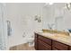 Bright bathroom features a granite-topped vanity with wood cabinets and stylish wood-look tile flooring at 15550 S 5Th Ave # 140, Phoenix, AZ 85045