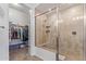 Bathroom featuring a tiled shower with glass door and a peek into a walk-in closet at 15550 S 5Th Ave # 140, Phoenix, AZ 85045