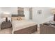 Bedroom features a wood bed frame with decorative pillows, two windows, and matching nightstands at 15550 S 5Th Ave # 140, Phoenix, AZ 85045