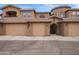 Attractive exterior showcasing a multi-unit building with garages, neutral colors, and well-maintained landscaping at 15550 S 5Th Ave # 140, Phoenix, AZ 85045