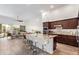 Open floor plan showcasing kitchen with island seating flowing into a living area with natural light at 15550 S 5Th Ave # 140, Phoenix, AZ 85045