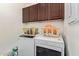 Laundry room with a front loading washer and dryer and upper cabinets for storage at 15550 S 5Th Ave # 140, Phoenix, AZ 85045
