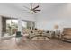 Bright living room with a ceiling fan, sliding glass doors to a balcony, and comfortable seating arrangement at 15550 S 5Th Ave # 140, Phoenix, AZ 85045