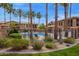 Community pool surrounded by palm trees and well-maintained landscaping at 15550 S 5Th Ave # 140, Phoenix, AZ 85045