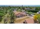 An exterior view of a house with mature trees, a well maintained lawn, and patio at 1637 S Los Alamos Cir, Mesa, AZ 85204