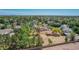 An aerial view of a home with mature trees and desert landscaping in a quiet neighborhood at 1637 S Los Alamos Cir, Mesa, AZ 85204