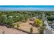 An elevated view of a sprawling property, featuring desert landscaping, mature trees, and a terracotta-roofed home at 1637 S Los Alamos Cir, Mesa, AZ 85204