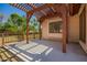 Back patio featuring a pergola with views of the backyard and mature trees at 1637 S Los Alamos Cir, Mesa, AZ 85204