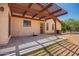 Stucco home featuring a covered back patio overlooking the landscaped backyard at 1637 S Los Alamos Cir, Mesa, AZ 85204