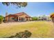 Spacious backyard with lush landscaping, mature shade trees and a horse fence at 1637 S Los Alamos Cir, Mesa, AZ 85204