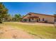 Expansive backyard with patio, mature landscaping, horse property, and perimeter fencing at 1637 S Los Alamos Cir, Mesa, AZ 85204