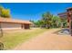 View of backyard, horse property, mature trees, barn, and direct access to the home's back patio at 1637 S Los Alamos Cir, Mesa, AZ 85204