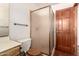 Bathroom featuring a glass enclosed shower, toilet, and wooden vanity at 1637 S Los Alamos Cir, Mesa, AZ 85204