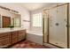 Bathroom features a double sink vanity, soaking tub, and glass shower at 1637 S Los Alamos Cir, Mesa, AZ 85204