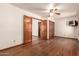 Bedroom with hardwood floors, ceiling fan, and multiple doorways at 1637 S Los Alamos Cir, Mesa, AZ 85204