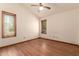 Bedroom with windows, ceiling fan, and hardwood floors at 1637 S Los Alamos Cir, Mesa, AZ 85204