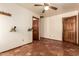 Bedroom with decorative wall racks and tiled flooring and doors leading to other rooms at 1637 S Los Alamos Cir, Mesa, AZ 85204