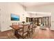 Open concept dining room with wood floors, a vaulted ceiling, and access to the living area at 1637 S Los Alamos Cir, Mesa, AZ 85204