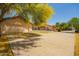 Large driveway leading to a garage and a spacious backyard with lush landscaping at 1637 S Los Alamos Cir, Mesa, AZ 85204