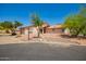 Inviting single-story home with a terracotta roof, desert landscaping, and mature trees at 1637 S Los Alamos Cir, Mesa, AZ 85204