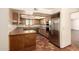 Traditional kitchen featuring wood cabinets, stainless steel appliances, and terra cotta tile flooring at 1637 S Los Alamos Cir, Mesa, AZ 85204