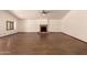 Open living room boasts hardwood floors, high ceilings, and brick fireplace at 1637 S Los Alamos Cir, Mesa, AZ 85204