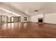 Spacious living room with vaulted ceiling, brick fireplace, ceiling fans, and light hardwood floors at 1637 S Los Alamos Cir, Mesa, AZ 85204