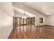Large living room with hardwood floors, high ceilings, abundant windows, and a statement light fixture at 1637 S Los Alamos Cir, Mesa, AZ 85204