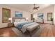 Spacious main bedroom with hardwood floors, a vaulted ceiling, and bright natural light at 1637 S Los Alamos Cir, Mesa, AZ 85204