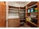 Pantry area with wood shelving and cabinets at 1637 S Los Alamos Cir, Mesa, AZ 85204