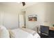Bright bedroom with a desk and a mounted TV screen. It is clean and organized at 16600 N Thompson Peak Pkwy # 2050, Scottsdale, AZ 85260