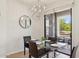 Chic dining area with modern chandelier, glass table, and balcony access for delightful meals and entertainment at 16600 N Thompson Peak Pkwy # 2050, Scottsdale, AZ 85260