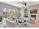 Cozy living room with fireplace, mounted TV, comfortable seating and bright natural light at 16600 N Thompson Peak Pkwy # 2050, Scottsdale, AZ 85260